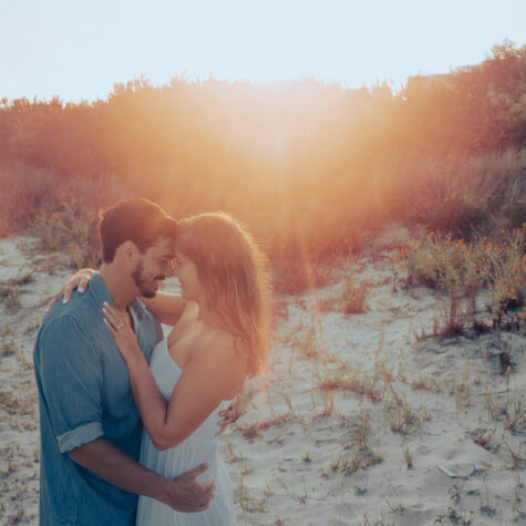 Beach girl and guy kiss on beach sunset