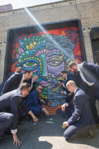 Groomsmen nyc playing dice in graffiti alley