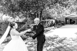 Bride hugging grandfather at church candid moment