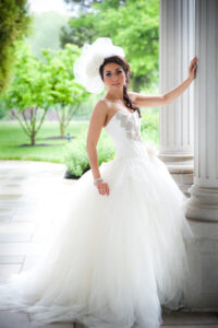 Luxury fancy bride dress portrait by columns