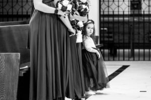Flower girl with bridesmaids black and white in church