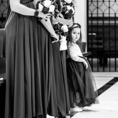 Flower girl with bridesmaids black and white in church