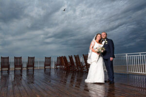Bride and groom on deck in rain cape may