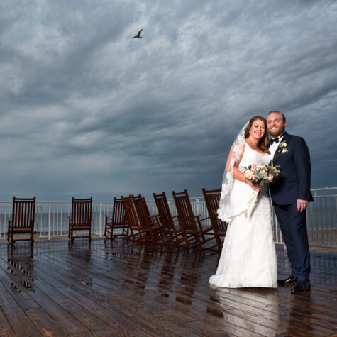 Bride and groom on deck in rain cape may