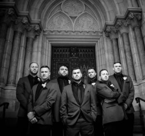 Dramatic Groomsmen group photo on church steps black and white