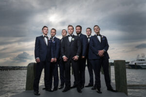 Dramatic groomsmen portrait on dock