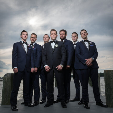 Dramatic groomsmen portrait on dock