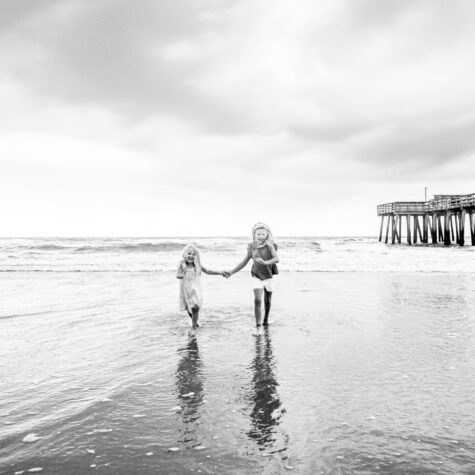 Black and white kids running on beach