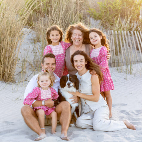 Family sitting on beach dunes