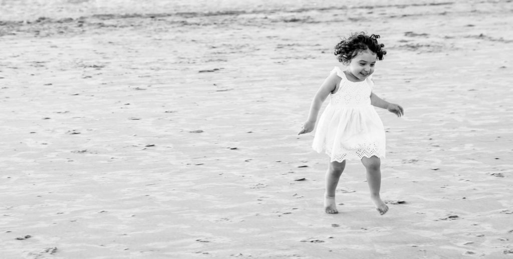 little girl in dress on beach