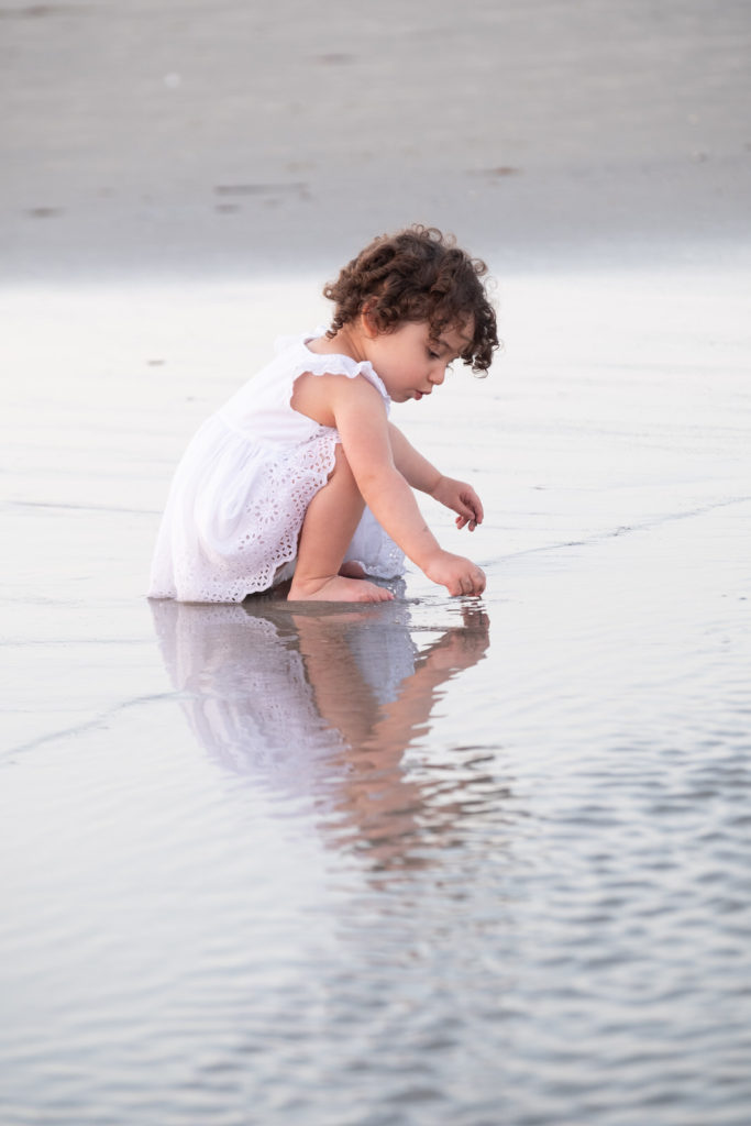 little girl playing in ocean