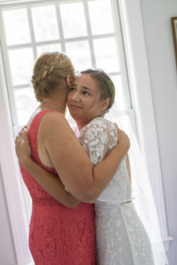 Bride and mom hug