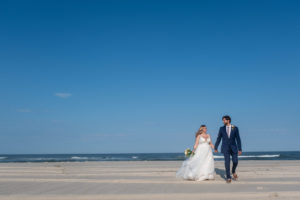 wedding couple on beach walking