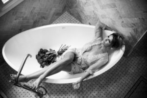Girl in lingerie in bathtub