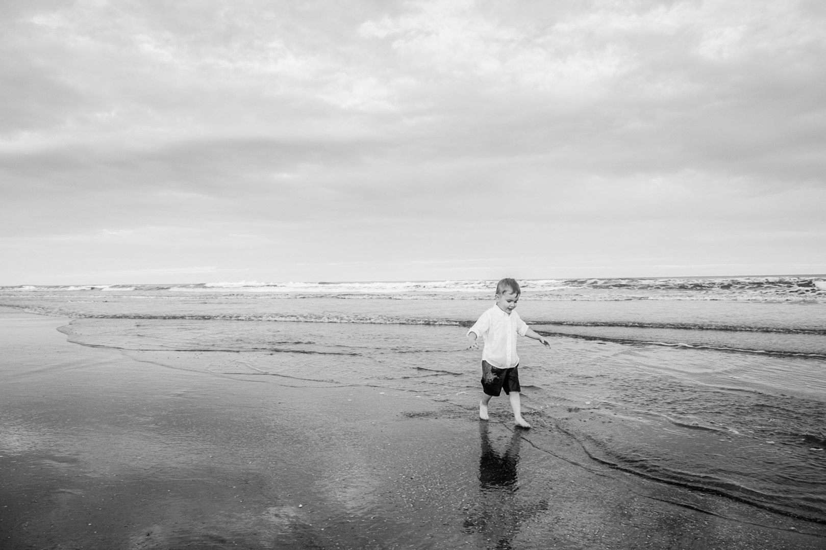boy play by ocean