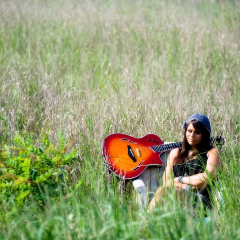 girl with guitar in field