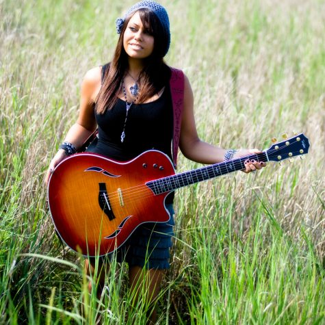 girl with guitar in field