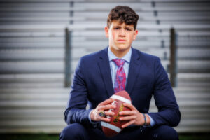 senior football payer in suit
