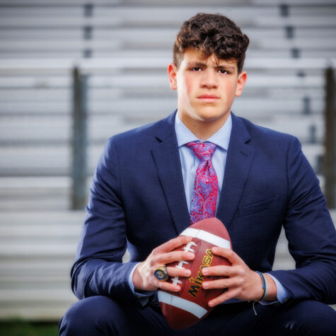 senior football payer in suit