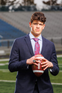 Senior football player in suit with ball
