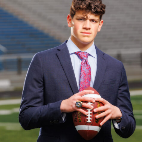 Senior football player in suit with ball
