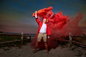 graduation cap and gown with color smoke bomb