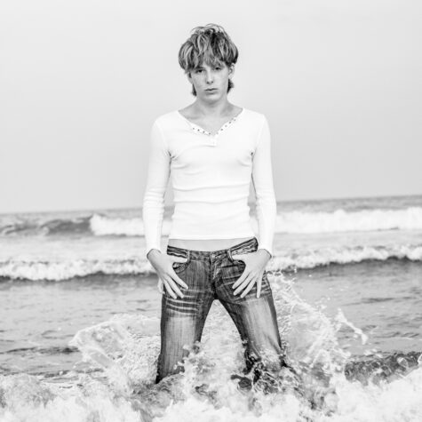senior boy in ocean in clothes