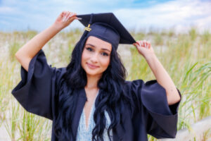 senior cap and gown on beach