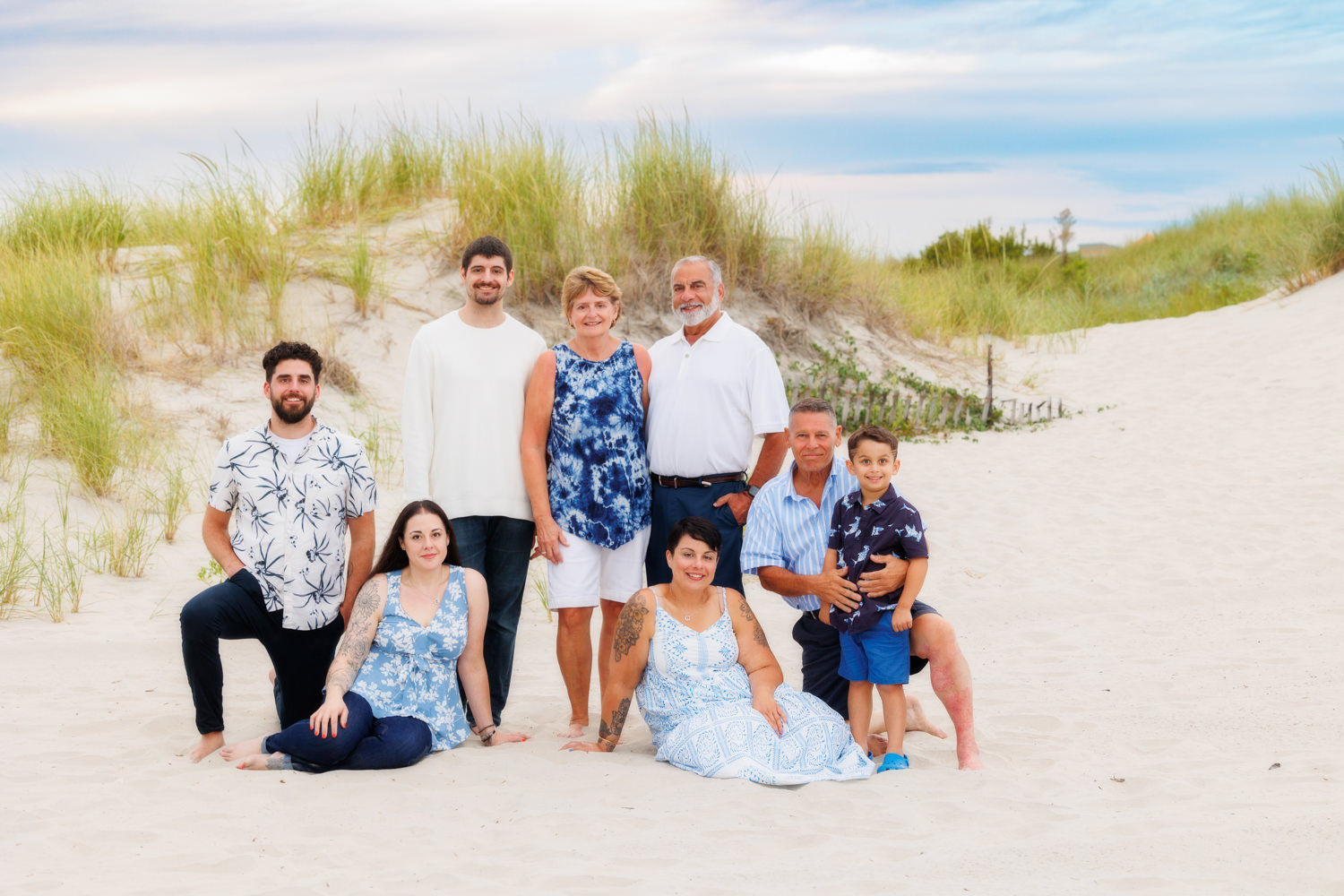 Beach family sitting in sand