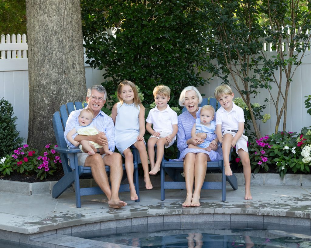 Family photos in backyard by pool