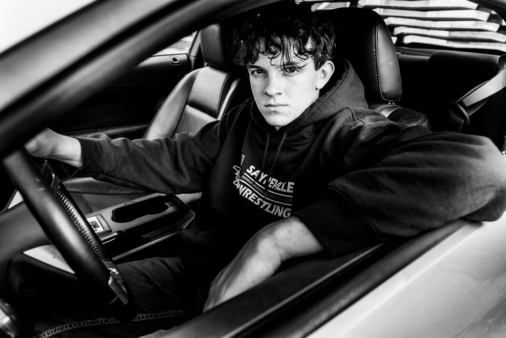 Boy in car driver seat