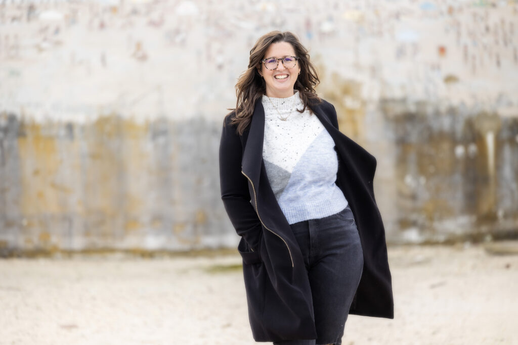 Girl twirling in long coat smiling having fun