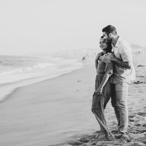 Engaged couple on beach black and white