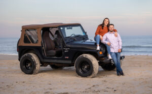 couple on beach with Jeep