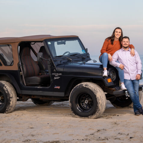 couple on beach with Jeep