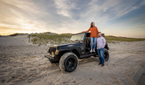 couple on beach with Jeep