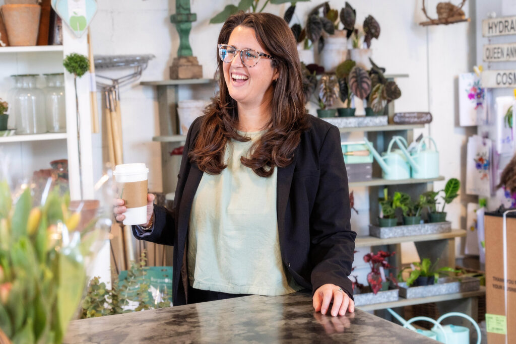 Woman in coffee shop laughing talking