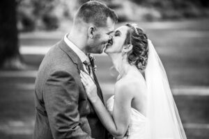 Bride and groom smile kiss