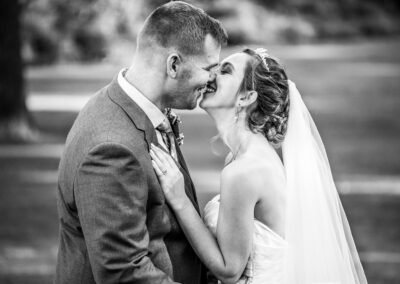 Bride and groom smile kiss