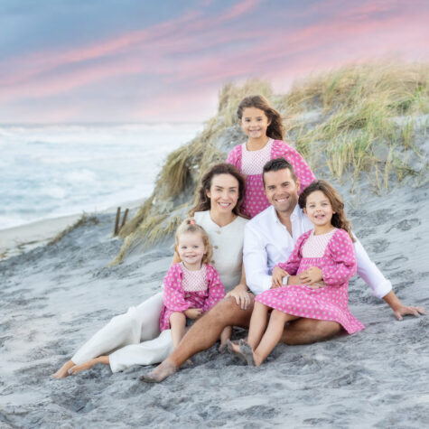 Family sitting on beach dunes