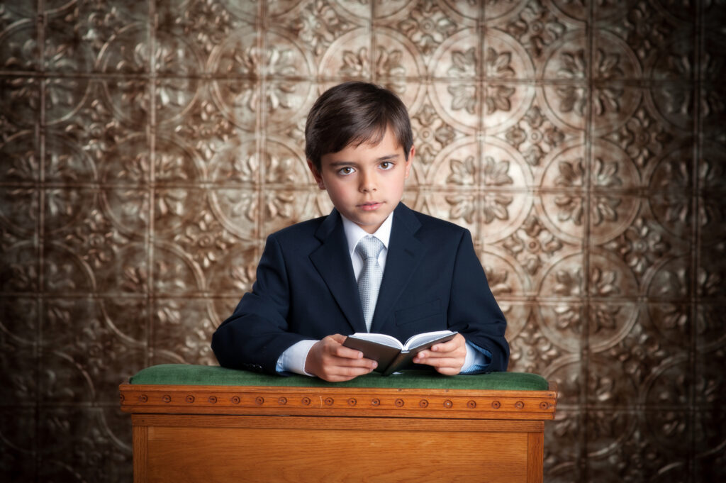 Boy kneeling with bible communion portrait