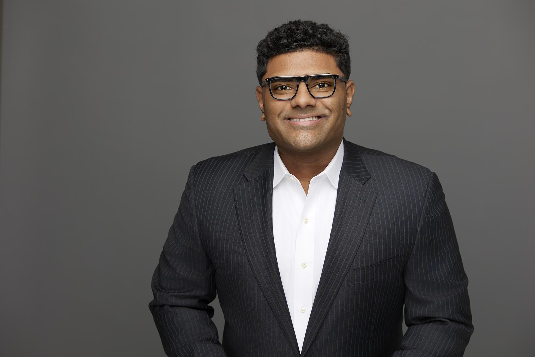 Headshot photo of business man in suit