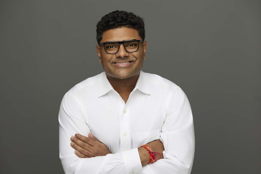 Headshot portrait of man in white shirt