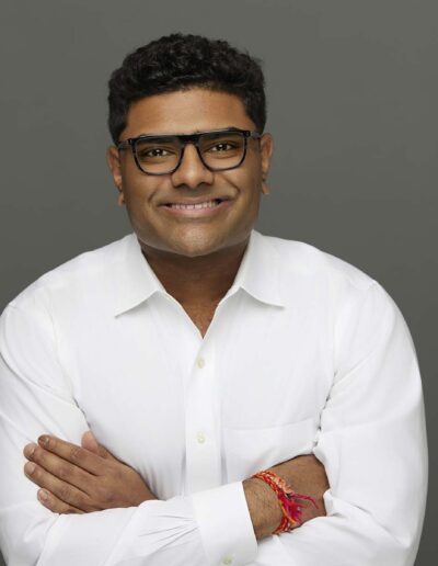 Headshot portrait of man in white shirt