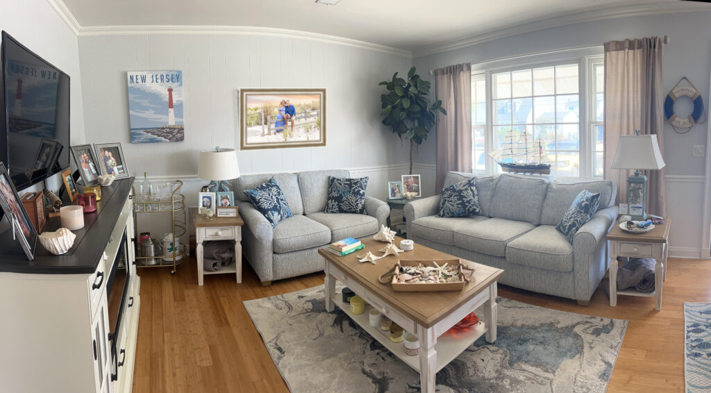 Living room with coastal beach colors with framed family portrait as focal point on wall