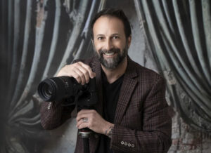 Headshot of photographer with camera