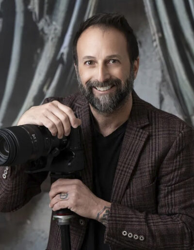 Headshot of photographer with camera