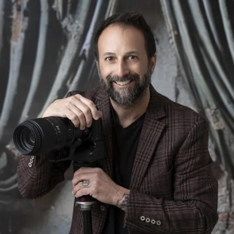 Headshot of photographer with camera