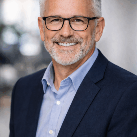 Man with glasses headshot casual business