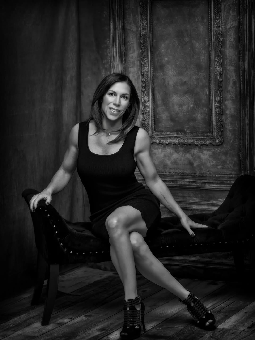 Toned fit woman in black dress studio portrait